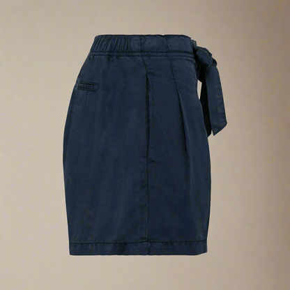 Side profile view of women's navy Tencel string bow shorts against a neutral background.